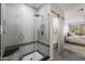 Bathroom featuring a glass shower and a view of the bedroom, blending luxury with scenic views at 25555 N Windy Walk Dr # 34, Scottsdale, AZ 85255