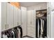 Spacious walk-in closet with custom shelving, drawers, and hanging rods for optimal organization at 25555 N Windy Walk Dr # 34, Scottsdale, AZ 85255