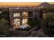 Sunset view of the home's facade with a patio and outdoor seating at 25555 N Windy Walk Dr # 34, Scottsdale, AZ 85255