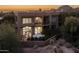 Stunning exterior view of a multi-story home with a balcony and manicured landscaping at 25555 N Windy Walk Dr # 34, Scottsdale, AZ 85255