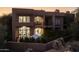 Stunning exterior view of a multi-story home with a balcony and manicured landscaping at 25555 N Windy Walk Dr # 34, Scottsdale, AZ 85255