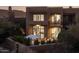 Stunning exterior view of a multi-story home with a balcony and manicured landscaping at 25555 N Windy Walk Dr # 34, Scottsdale, AZ 85255
