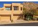 Desert home features a two-car garage and well-maintained landscaping with desert plants at 25555 N Windy Walk Dr # 34, Scottsdale, AZ 85255