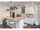 Modern kitchen with a stylish island, stainless steel appliances, and sleek white cabinetry at 25555 N Windy Walk Dr # 34, Scottsdale, AZ 85255