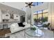 Bright living room featuring a modern design with soaring ceilings and scenic outdoor views at 25555 N Windy Walk Dr # 34, Scottsdale, AZ 85255