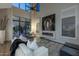 Modern living room with floor-to-ceiling windows, fireplace, and desert views at 25555 N Windy Walk Dr # 34, Scottsdale, AZ 85255