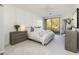 Bright bedroom with a large bed, soft carpet, and a sliding glass door leading to a balcony at 25555 N Windy Walk Dr # 34, Scottsdale, AZ 85255