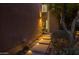 Illuminated walkway leads to the entrance of this desert home, lined with desert landscaping at 25555 N Windy Walk Dr # 34, Scottsdale, AZ 85255