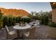 Inviting outdoor patio featuring a dining table and grill with mountain views and lush greenery at 25555 N Windy Walk Dr # 34, Scottsdale, AZ 85255