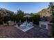 Inviting outdoor patio featuring a dining table and grill with mountain views and lush greenery at 25555 N Windy Walk Dr # 34, Scottsdale, AZ 85255