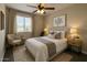 A well-decorated bedroom featuring calming neutral tones, large window, and soft lighting at 2634 S 63Rd Dr, Phoenix, AZ 85043