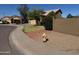 A two-story home with a neutral-colored exterior, with a lawn and shrubbery at 2634 S 63Rd Dr, Phoenix, AZ 85043
