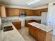 Spacious kitchen featuring granite countertops, a center island, stainless steel appliances, and custom cabinetry at 2634 S 63Rd Dr, Phoenix, AZ 85043
