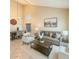 Bright living room featuring a modern sofa set, neutral paint and ample lighting at 2634 S 63Rd Dr, Phoenix, AZ 85043