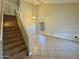 Inviting living room showcasing high ceilings, neutral walls, tiled floor, and a staircase to the second level at 2634 S 63Rd Dr, Phoenix, AZ 85043