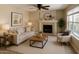 Inviting living room with a fireplace, soft lighting, and contemporary decor creating a relaxing atmosphere at 2634 S 63Rd Dr, Phoenix, AZ 85043