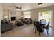 Cozy living room with a fireplace, comfortable seating, and a dining area, ideal for gatherings at 2634 S 63Rd Dr, Phoenix, AZ 85043
