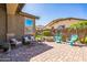 Back patio featuring comfortable seating, a fire pit, and well-manicured landscaping at 277 E Kaibab Dr, Chandler, AZ 85249