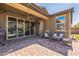 Spacious covered back patio with brick flooring, outdoor seating and ceiling fan at 277 E Kaibab Dr, Chandler, AZ 85249