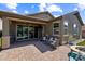A spacious covered back patio has brick flooring, patio furniture, and a ceiling fan at 277 E Kaibab Dr, Chandler, AZ 85249
