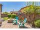 Cozy backyard patio features comfortable Adirondack chairs, a fire pit, and beautifully landscaped desert plants at 277 E Kaibab Dr, Chandler, AZ 85249