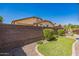 Backyard featuring a brick wall, manicured lawn, and mature landscaping at 277 E Kaibab Dr, Chandler, AZ 85249