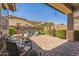 Inviting backyard featuring a brick patio, outdoor seating, fire pit, and lush landscaping with palm trees and desert plants at 277 E Kaibab Dr, Chandler, AZ 85249