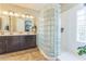 Bathroom featuring a double vanity, large mirror, and a unique glass block shower at 277 E Kaibab Dr, Chandler, AZ 85249