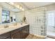 Bathroom features double vanity, large mirror, and decorative glass block partition at 277 E Kaibab Dr, Chandler, AZ 85249