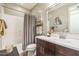 Bathroom with updated vanity, framed mirror, shower with curtain, and decorative accents at 277 E Kaibab Dr, Chandler, AZ 85249