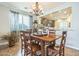 Dining area features a wooden table with views through sheer curtains to the front yard at 277 E Kaibab Dr, Chandler, AZ 85249