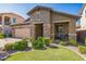 Charming home featuring a well-manicured lawn, stone accents, and a cozy front porch, exuding curb appeal at 277 E Kaibab Dr, Chandler, AZ 85249