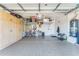 Clean and organized garage with ample storage cabinets, epoxy flooring, and well-lit interiors for practical use at 277 E Kaibab Dr, Chandler, AZ 85249