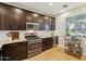 Well-equipped kitchen featuring dark wood cabinets and stainless-steel appliances at 277 E Kaibab Dr, Chandler, AZ 85249