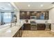 Spacious kitchen featuring dark wood cabinets, stainless steel appliances, and granite countertops at 277 E Kaibab Dr, Chandler, AZ 85249