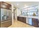 Spacious kitchen with stainless steel refrigerator and a breakfast bar at 277 E Kaibab Dr, Chandler, AZ 85249