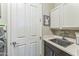 Functional laundry room with a sink, ample counter space, and cabinetry for efficient cleaning and storage at 277 E Kaibab Dr, Chandler, AZ 85249