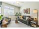 Bright living room featuring a comfortable gray sofa, and large window at 277 E Kaibab Dr, Chandler, AZ 85249