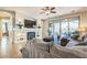 Cozy living room with fireplace, modern lighting, and sliding glass doors to backyard at 277 E Kaibab Dr, Chandler, AZ 85249