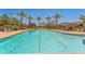 Beautiful community pool surrounded by palm trees and lounge chairs, perfect for relaxation and outdoor enjoyment at 277 E Kaibab Dr, Chandler, AZ 85249