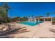 Community pool featuring lounge chairs, shade structures, and well-maintained landscaping at 277 E Kaibab Dr, Chandler, AZ 85249