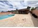 Backyard featuring a pool, concrete patio, partial view of the house, and privacy fencing at 2838 E Contessa St, Mesa, AZ 85213