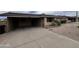 Home featuring desert landscaping, a long driveway leading to a covered carport, and solar panels on the roof at 2838 E Contessa St, Mesa, AZ 85213