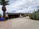 Exterior view of a home with a desert-themed yard, a covered parking area, and solar panels on the roof at 2838 E Contessa St, Mesa, AZ 85213
