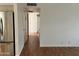 Long hallway with closet doors, and a stainless steel refrigerator on the left at 2838 E Contessa St, Mesa, AZ 85213