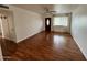 Living room featuring wood floors, ceiling fan, and dark stained wood front door at 2838 E Contessa St, Mesa, AZ 85213