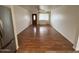 Bright living room with hardwood flooring, ceiling fan, and a view of the front door at 2838 E Contessa St, Mesa, AZ 85213