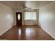 Bright living room featuring wood floors, a ceiling fan, and a front door with an oval window at 2838 E Contessa St, Mesa, AZ 85213