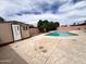 Backyard with a shed and a pool, surrounded by patterned concrete and a block fence at 2838 E Contessa St, Mesa, AZ 85213