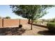 The backyard features low maintenance landscaping, mature trees, and block fence at 37252 N Big Bend Rd, San Tan Valley, AZ 85140